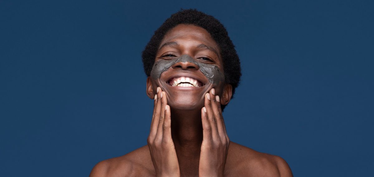 portrait-handsome-man-applying-charcoal-face-mask